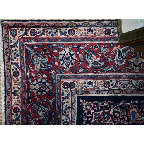 841 - A fine Persian hand-made Tabriz carpet, the blue ground centred by a medallion, 368 cm x 265 cm