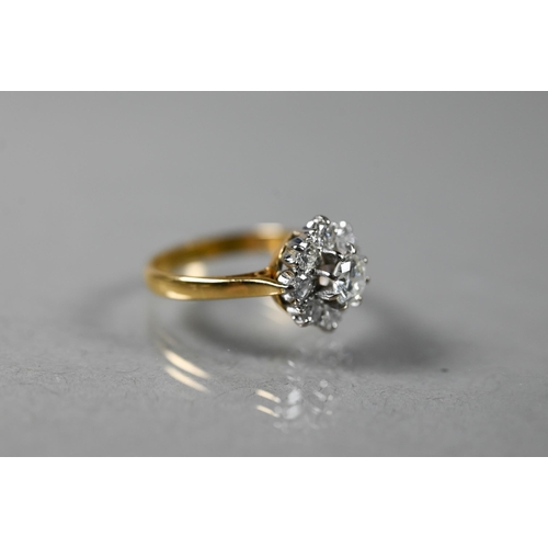 220A - A diamond cluster ring, the central brilliant cut diamond surrounded by eight smaller diamonds in th... 