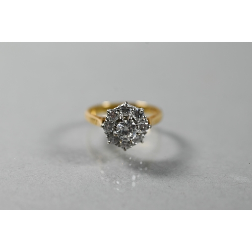 220A - A diamond cluster ring, the central brilliant cut diamond surrounded by eight smaller diamonds in th... 