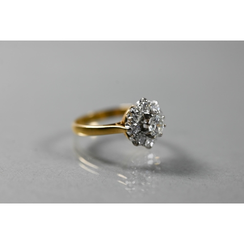 220A - A diamond cluster ring, the central brilliant cut diamond surrounded by eight smaller diamonds in th... 