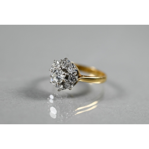 220A - A diamond cluster ring, the central brilliant cut diamond surrounded by eight smaller diamonds in th... 