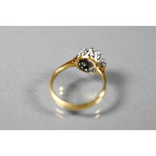 220A - A diamond cluster ring, the central brilliant cut diamond surrounded by eight smaller diamonds in th... 