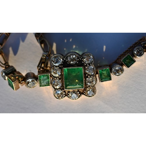 318 - An emerald and diamond cluster bracelet, the central rectangular baguette cut emerald surrounded by ... 