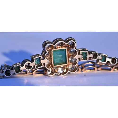 318 - An emerald and diamond cluster bracelet, the central rectangular baguette cut emerald surrounded by ... 