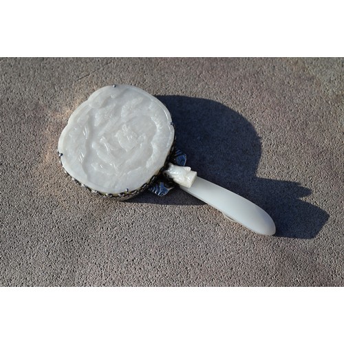 430 - A 19th century Chinese white jade and white metal mounted hand mirror, Qing dynasty, with cloud shap... 