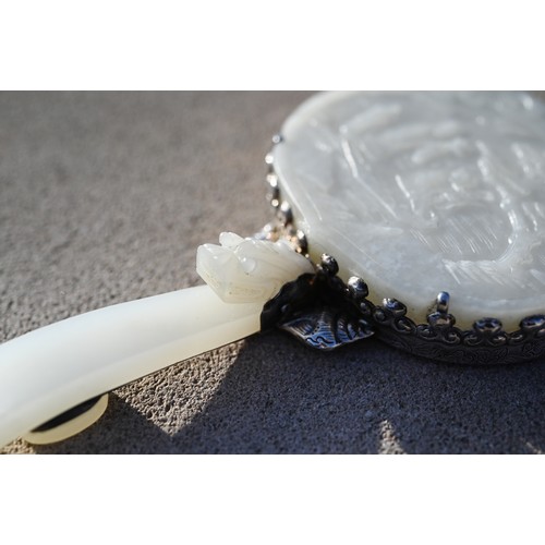 430 - A 19th century Chinese white jade and white metal mounted hand mirror, Qing dynasty, with cloud shap... 