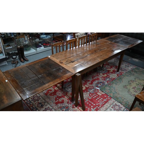 913 - An antique French fruitwood extending draw leaf dining table, with frieze drawer to one end, raised ... 