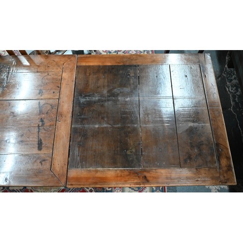 913 - An antique French fruitwood extending draw leaf dining table, with frieze drawer to one end, raised ... 