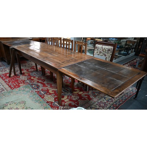 913 - An antique French fruitwood extending draw leaf dining table, with frieze drawer to one end, raised ... 