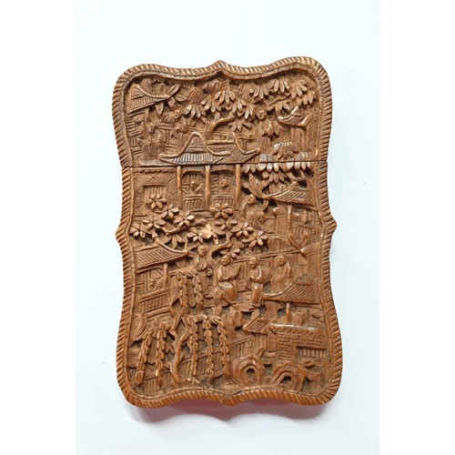 408 - A 19th century Chinese Canton sandalwood card case profusely carved with a village scene, dwellings ... 