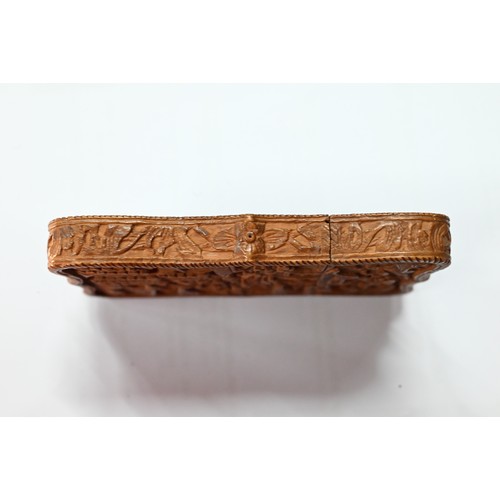 408 - A 19th century Chinese Canton sandalwood card case profusely carved with a village scene, dwellings ... 