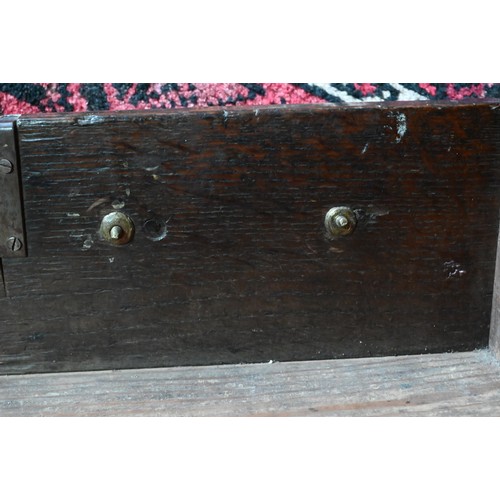 854 - An 18th century oak low dresser, the three plank top over an arrangement of five drawers and two cup... 