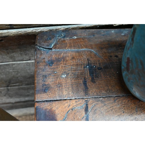 854 - An 18th century oak low dresser, the three plank top over an arrangement of five drawers and two cup... 