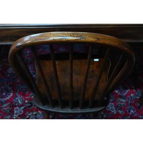 963 - A set of eight late 19th century elm and ash spindle back chairs with crinoline stretchers (8)