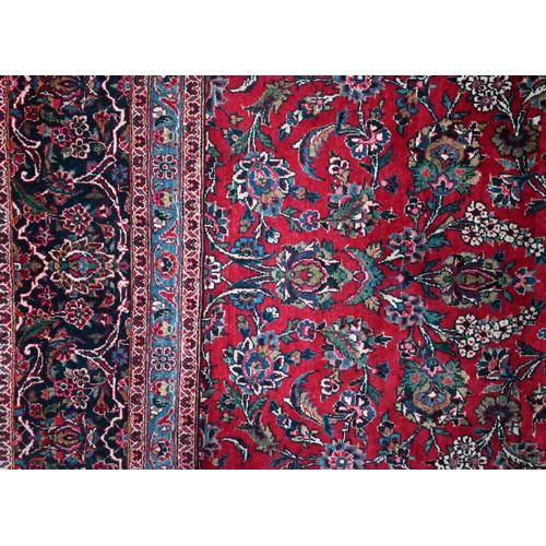 836 - A fine old Persian hand-made Kashan carpet, the red ground with repeating linked garden vine design,... 