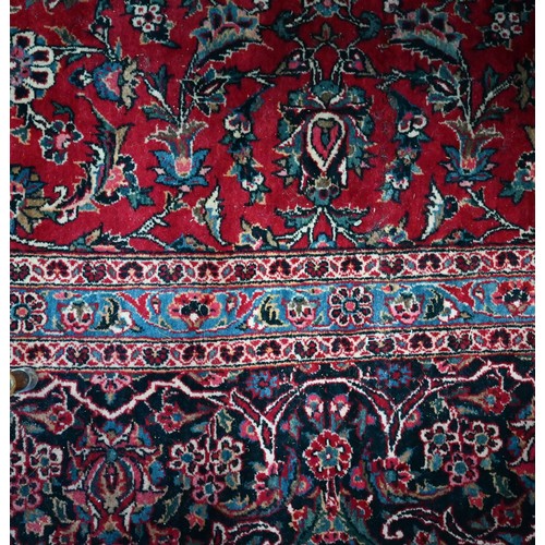 836 - A fine old Persian hand-made Kashan carpet, the red ground with repeating linked garden vine design,... 