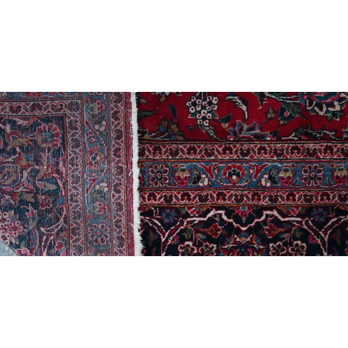 836 - A fine old Persian hand-made Kashan carpet, the red ground with repeating linked garden vine design,... 