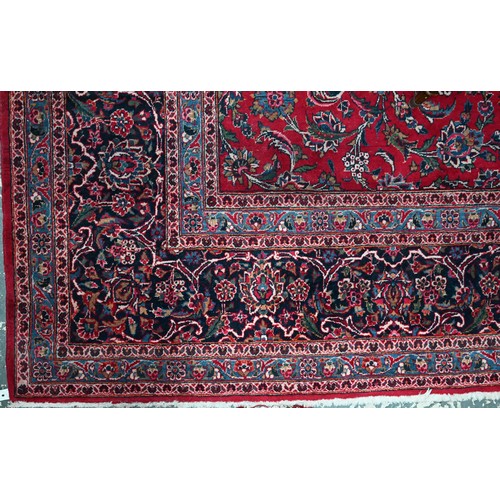 836 - A fine old Persian hand-made Kashan carpet, the red ground with repeating linked garden vine design,... 