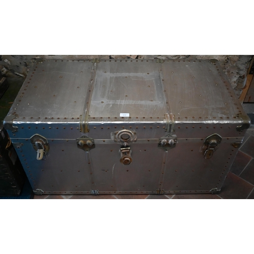 19 - A vintage rivetted aluminium flight trunk with leather handles and fabric lined interior