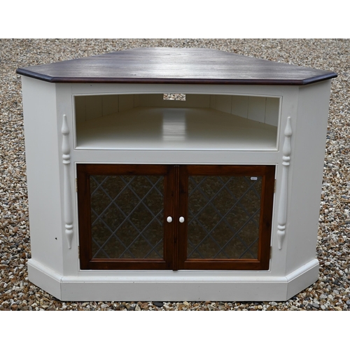 26 - #A stained pine top painted corner cabinet with pair of lattice lead glazed doors, on a plinth base,... 