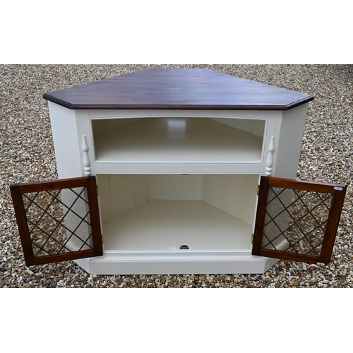 26 - #A stained pine top painted corner cabinet with pair of lattice lead glazed doors, on a plinth base,... 