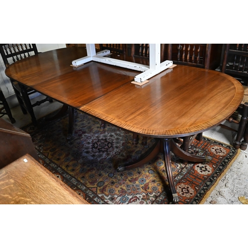 38 - A reproduction twin pedestal cross banded mahogany dining table with extension leaf, 156 (215 max.) ... 