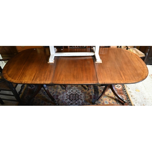 38 - A reproduction twin pedestal cross banded mahogany dining table with extension leaf, 156 (215 max.) ... 