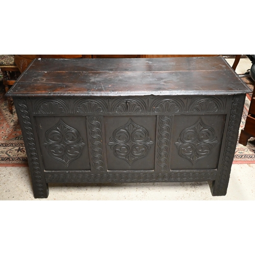 602 - An antique oak coffer with lunette and foliate carved panelled front, 130 cm wide x 58 cm deep x 76 ... 