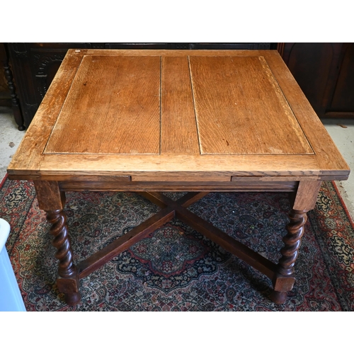 267 - An old oak draw leaf dining table on barleytwist legs united by a cross stretcher, 106 x 106 (181 op... 