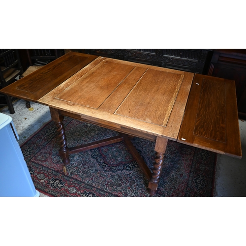 267 - An old oak draw leaf dining table on barleytwist legs united by a cross stretcher, 106 x 106 (181 op... 