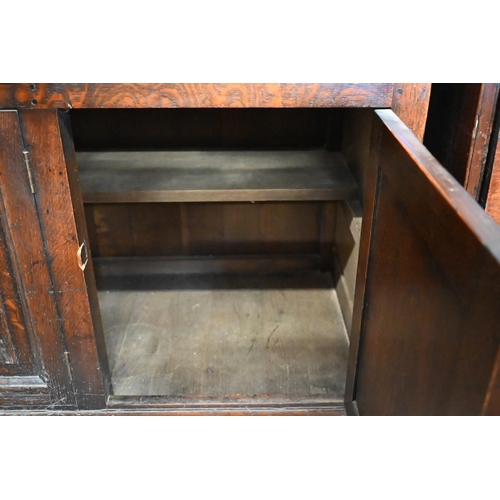 385 - An 18th century style provincial oak dresser, the raised plate rack with three open shelves on a bas... 