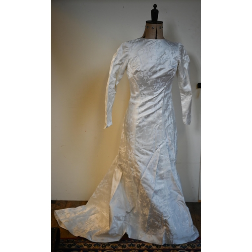 197 - A vintage cream wedding gown in heavy satin with printed floral sprigs, full length with buttoned ba... 