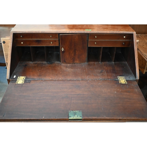 402 - A Georgian mahogany fall front bureau with fitted interior and four long graduating drawers standing... 