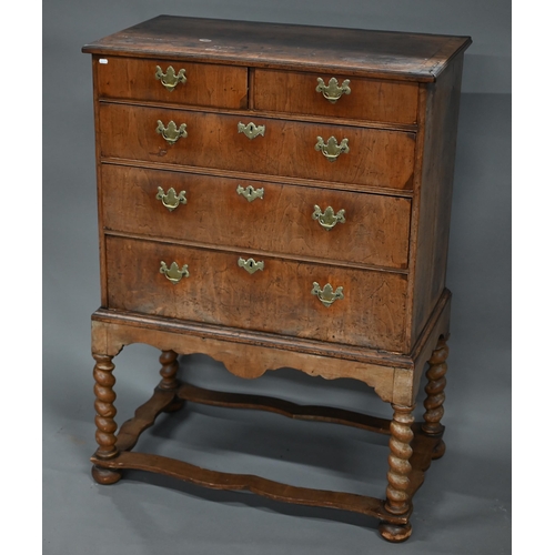 254 - An 18th century walnut chest on stand, with two short over three long graduated drawers with brass p... 