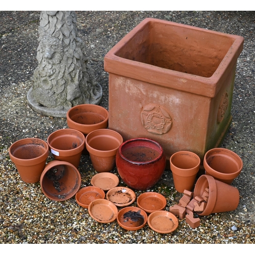 12 - A terracotta square planter with rose motif to/with assorted terracotta plant pots and a weathered r... 