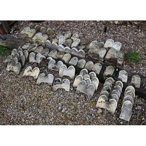 15 - A quantity of weathered cast stone Gothic arched style garden edging tiles, approx. 50 double arched... 