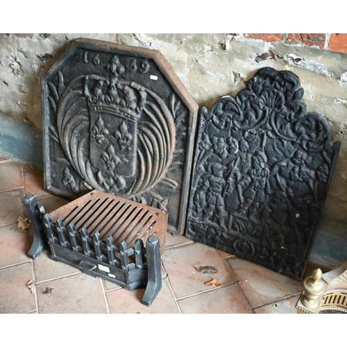 16 - Two traditional cast iron firebacks to/with a fire grate