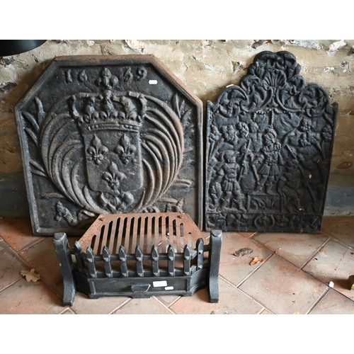 16 - Two traditional cast iron firebacks to/with a fire grate