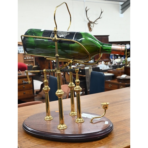 220 - Brass wine-decanting cradle with crank handle, on wooden base (for magnums)