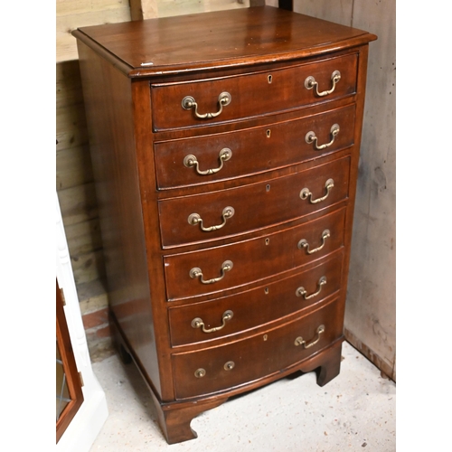 25 - A reproduction Georgian style mahogany six-drawer bow-fronted chest of drawers, raised on shaped bra... 