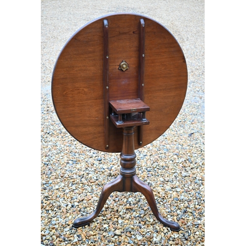 261 - A Georgian style mahogany tilt top table raised on a birdcage tripod base, 83 cm dia. x 74 cm h