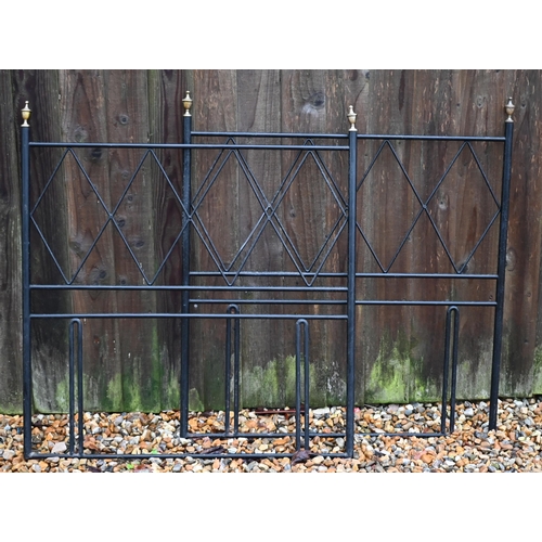27 - #A pair of black painted steel bed ends with brass finials, 89 cm w x 95 cm h (2)