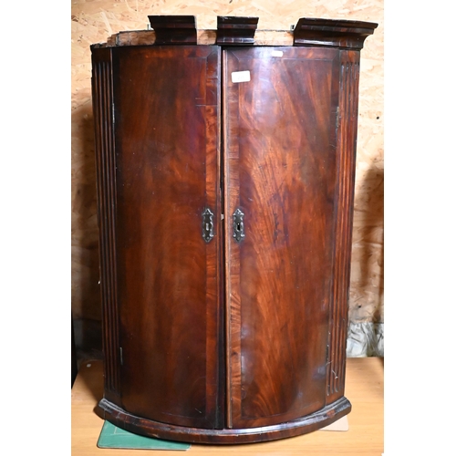 285 - #A George III bow-front hanging corner cupboard a/f