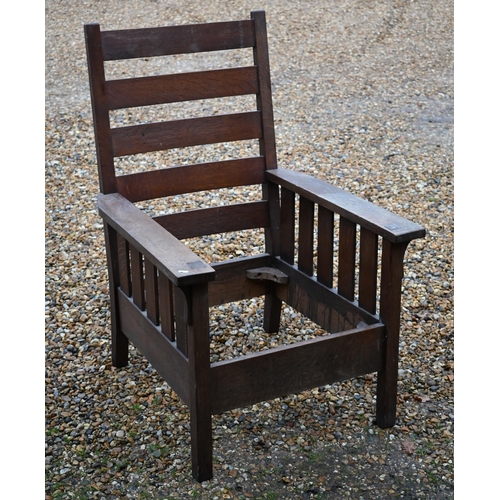 295 - An Art Deco period oak ladderback armchair, with seat cushions