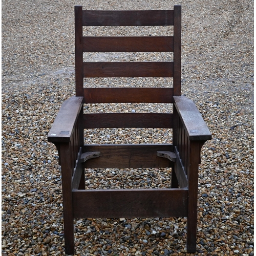 295 - An Art Deco period oak ladderback armchair, with seat cushions