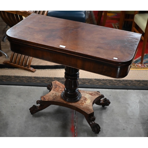 299 - A Regency mahogany fold-over tea table raised on a turned column and concave quadraform base with pa... 