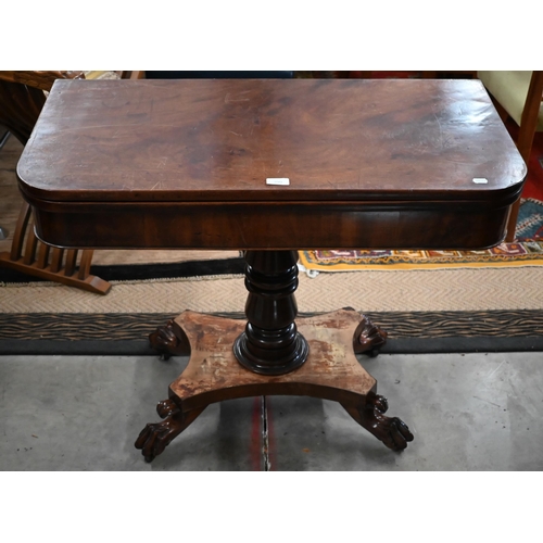 299 - A Regency mahogany fold-over tea table raised on a turned column and concave quadraform base with pa... 