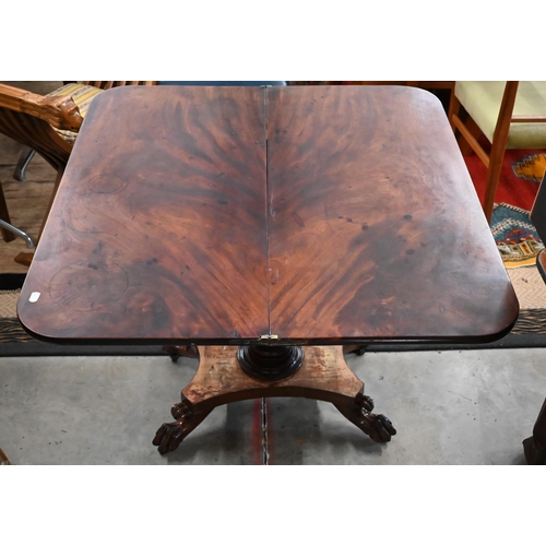 299 - A Regency mahogany fold-over tea table raised on a turned column and concave quadraform base with pa... 