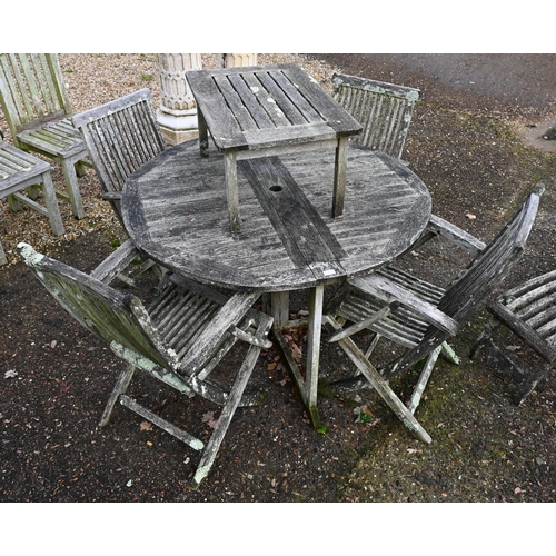 3 - A heavily weathered teak circular garden table and set of four armchairs to/w a pair of teak steamer... 