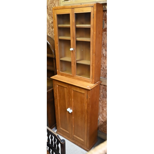 36 - A pine cupboard 73 cm x 31 cm x 108 cm h to/w a glazed-in pine cabinet 68 cm x 17 cm x 98 cm h (2)